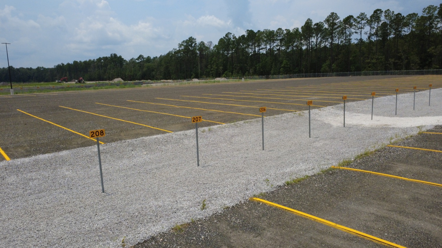 Marked stall lines and numbered posts at Riggy's Jacksonville - Pritchard Road truck parking lot